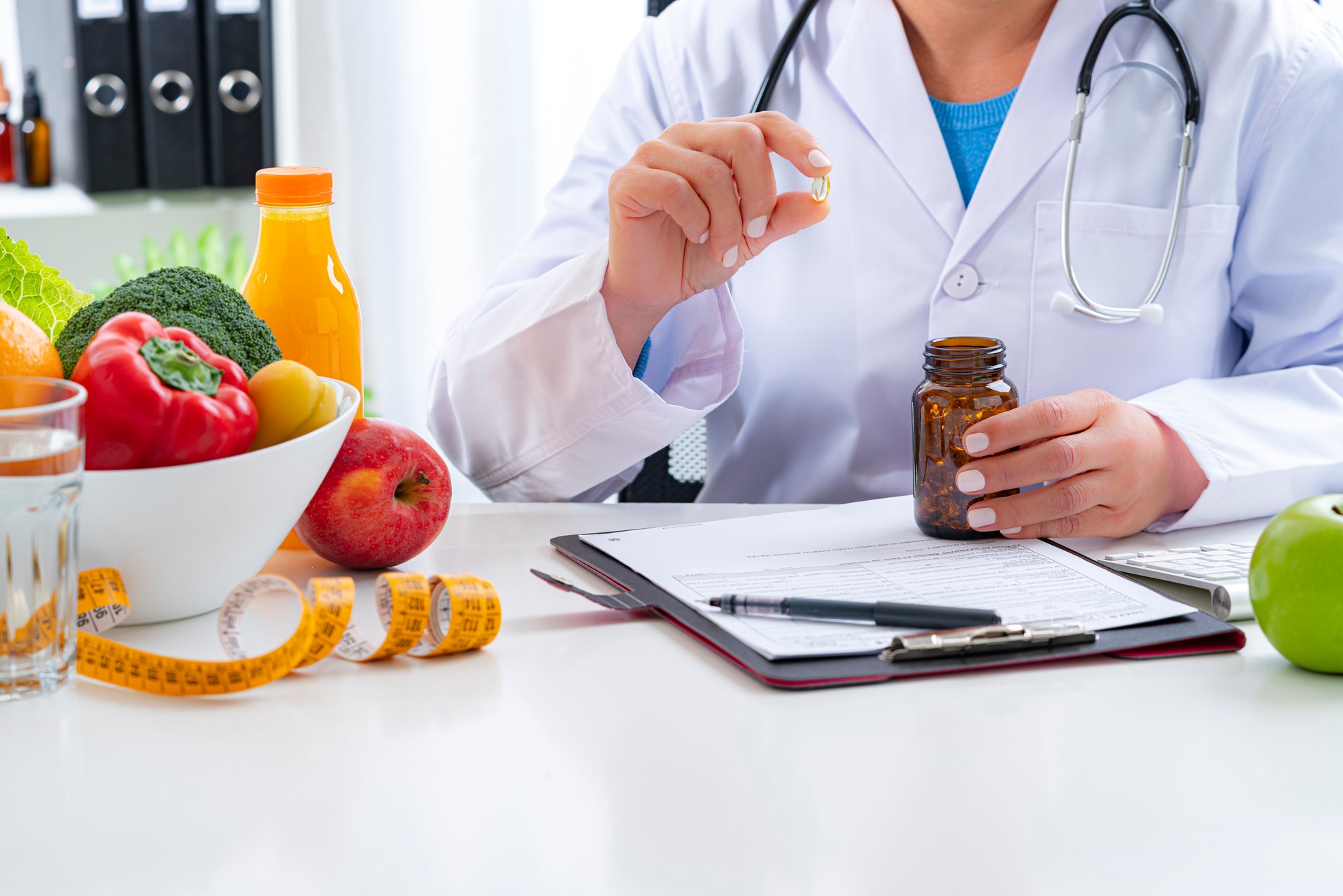 Nutritionist holding nutritional supplement capsule